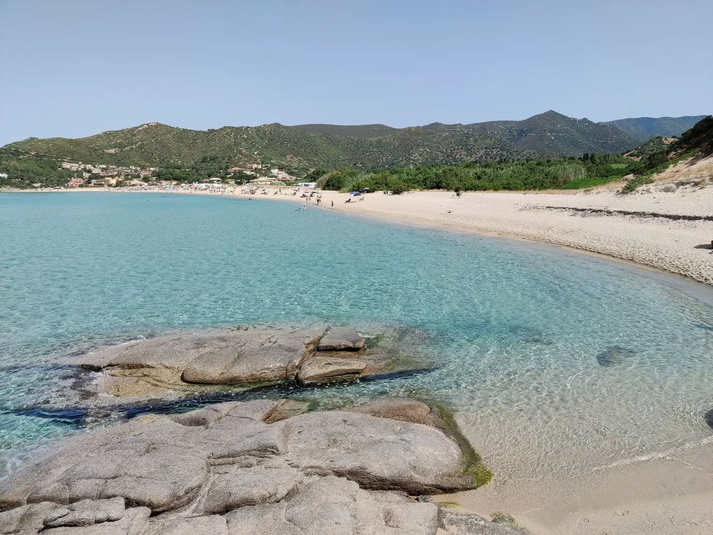 Pristine beach with turquoise water and scenic views, perfect for relaxation.