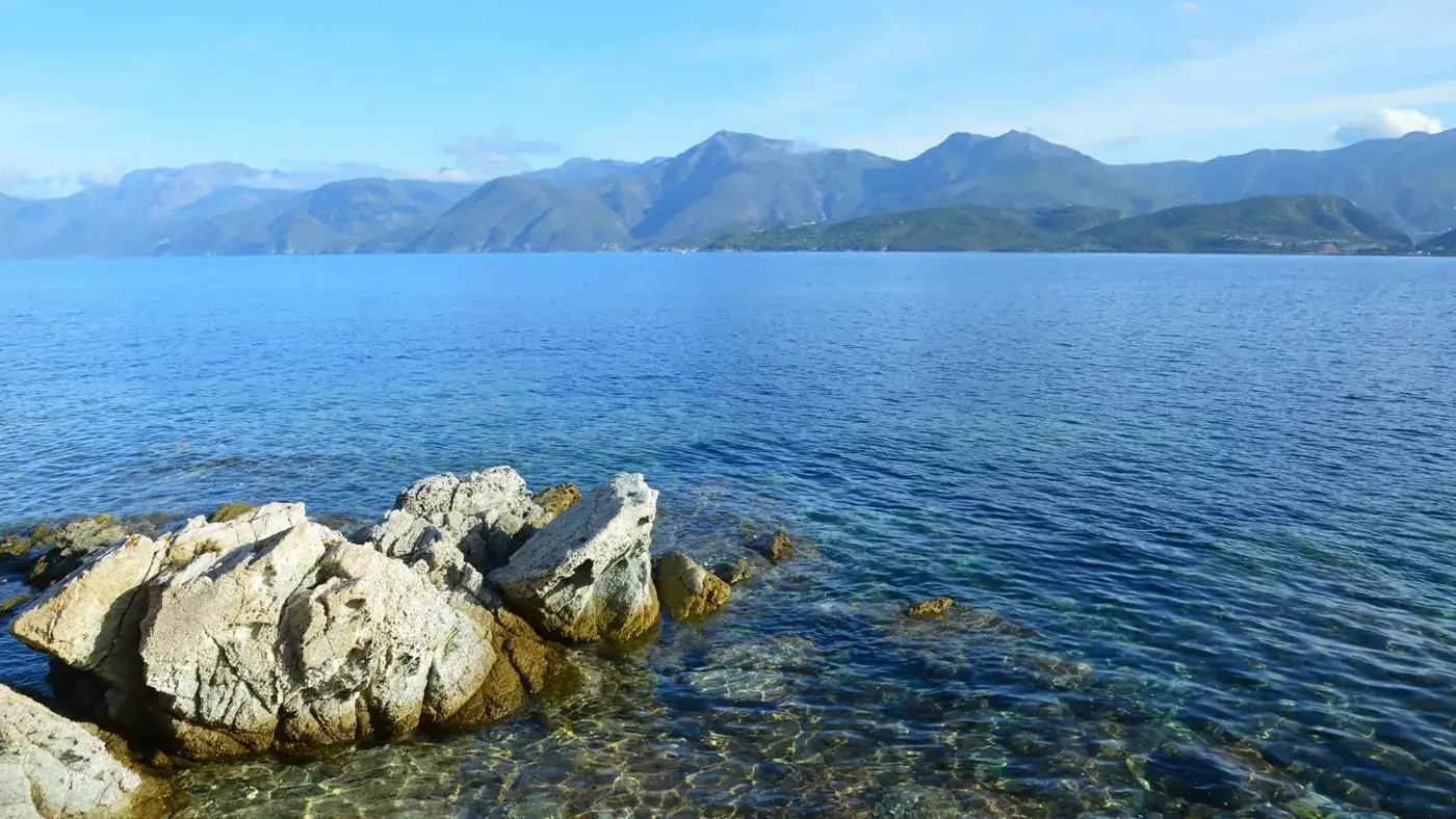 Breathtaking coastal view of Patrimonio, Corsica, featuring rocky shorelines and serene blue waters.