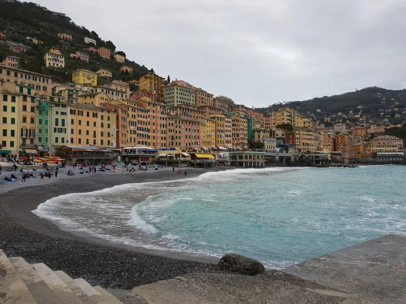 View of the colorful buildings along the Camogli seaside promenade in Italy, perfect for coastal travel imagery.