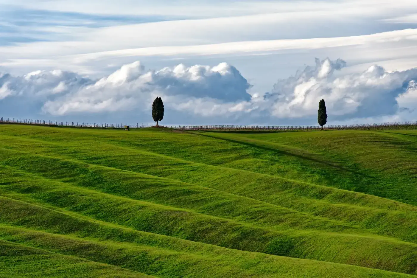 Beautiful rolling hills in Tuscany, Italy with dramatic clouds in the background.