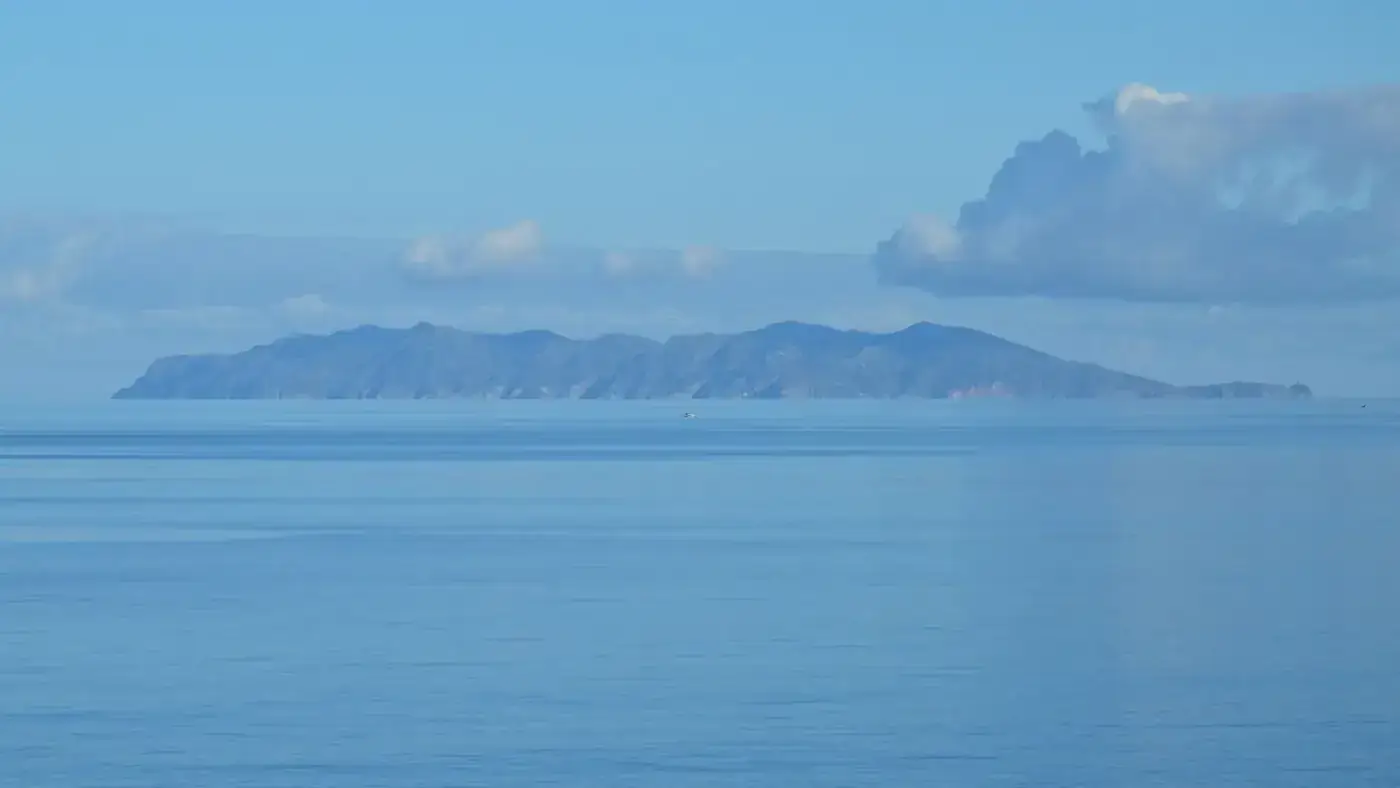 Peaceful seascape of Elba Island in Italy's Tuscany with clear blue skies.