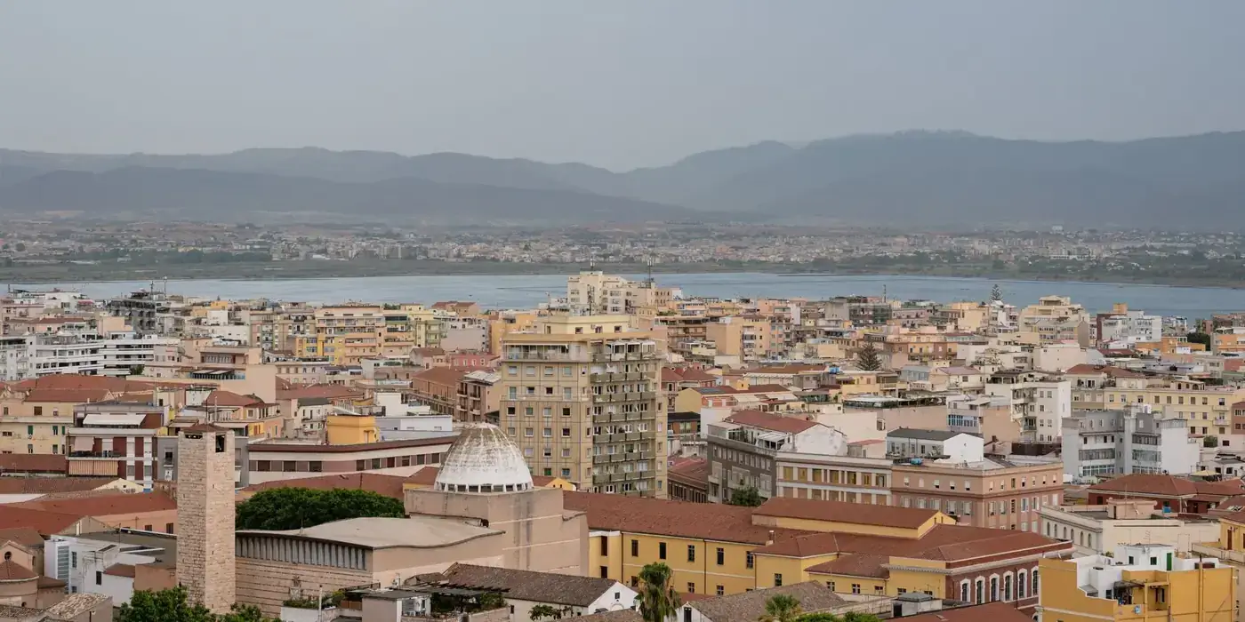 A picturesque skyline of Cagliari with a view of the waterfront and cityscape.
