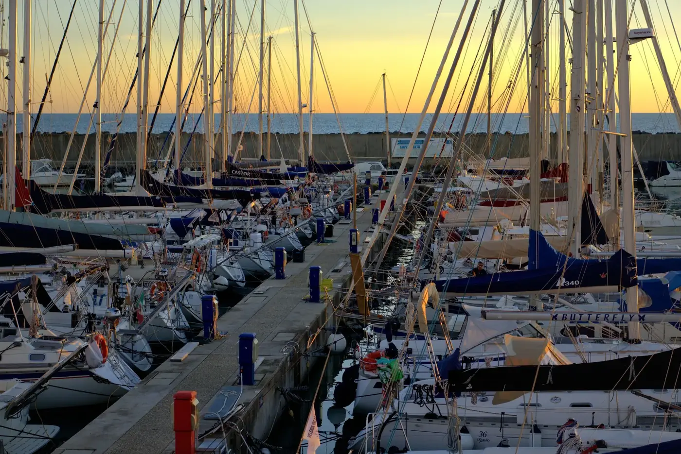 Scenic view of anchored boats at sunset in Lido di Ostia marina, Lazio, Italy.