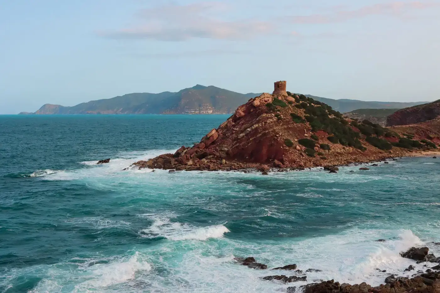 Beautiful seascape of Alghero coastline with waves crashing against rocky cliffs in Sardinia, Italy.