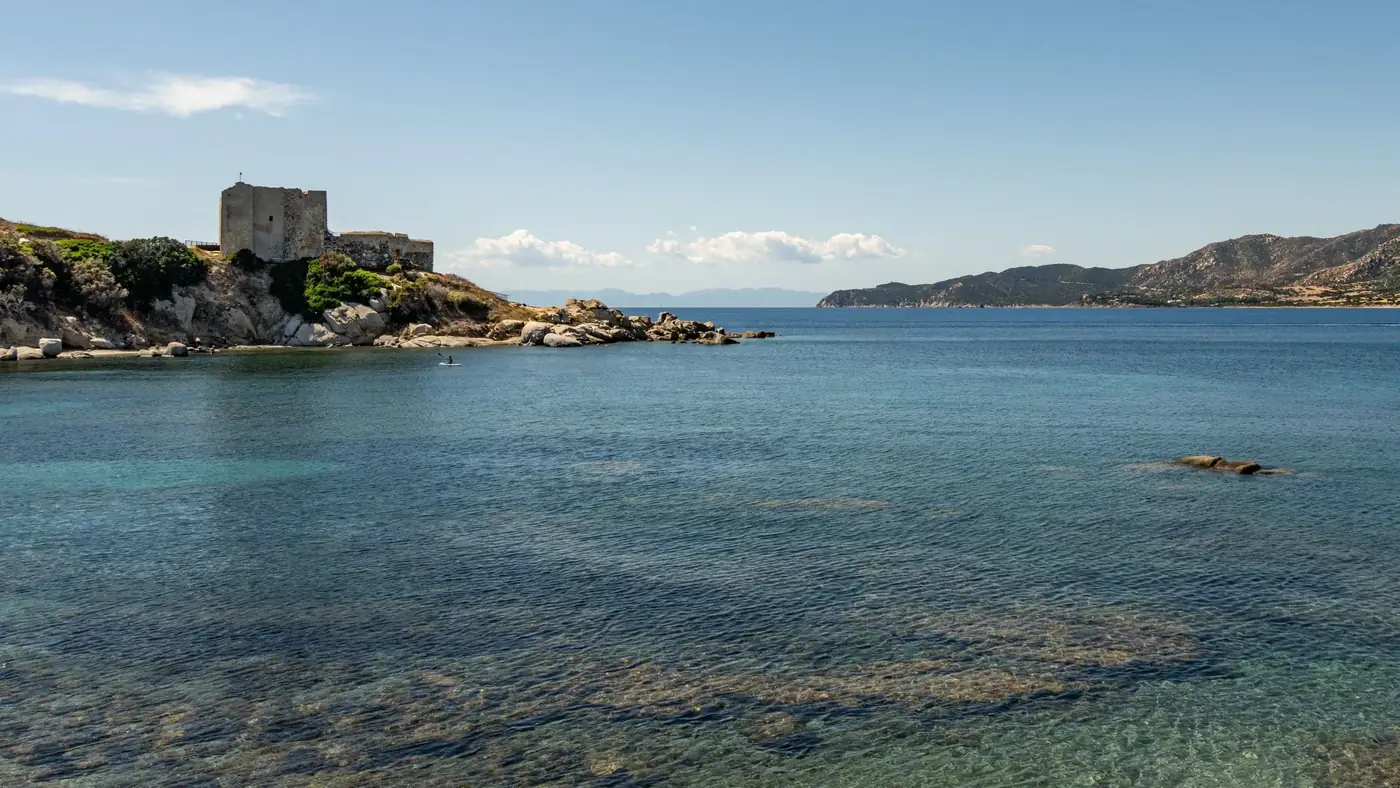 Explore the stunning coastal view of Fortezza Vecchia in Villasimius, Sardinia, Italy.