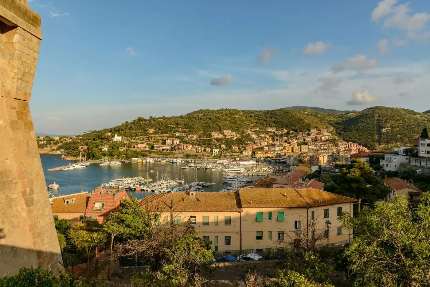 Stunning capture of Porto Ercole with a beautiful harbor and lush hills in the background.