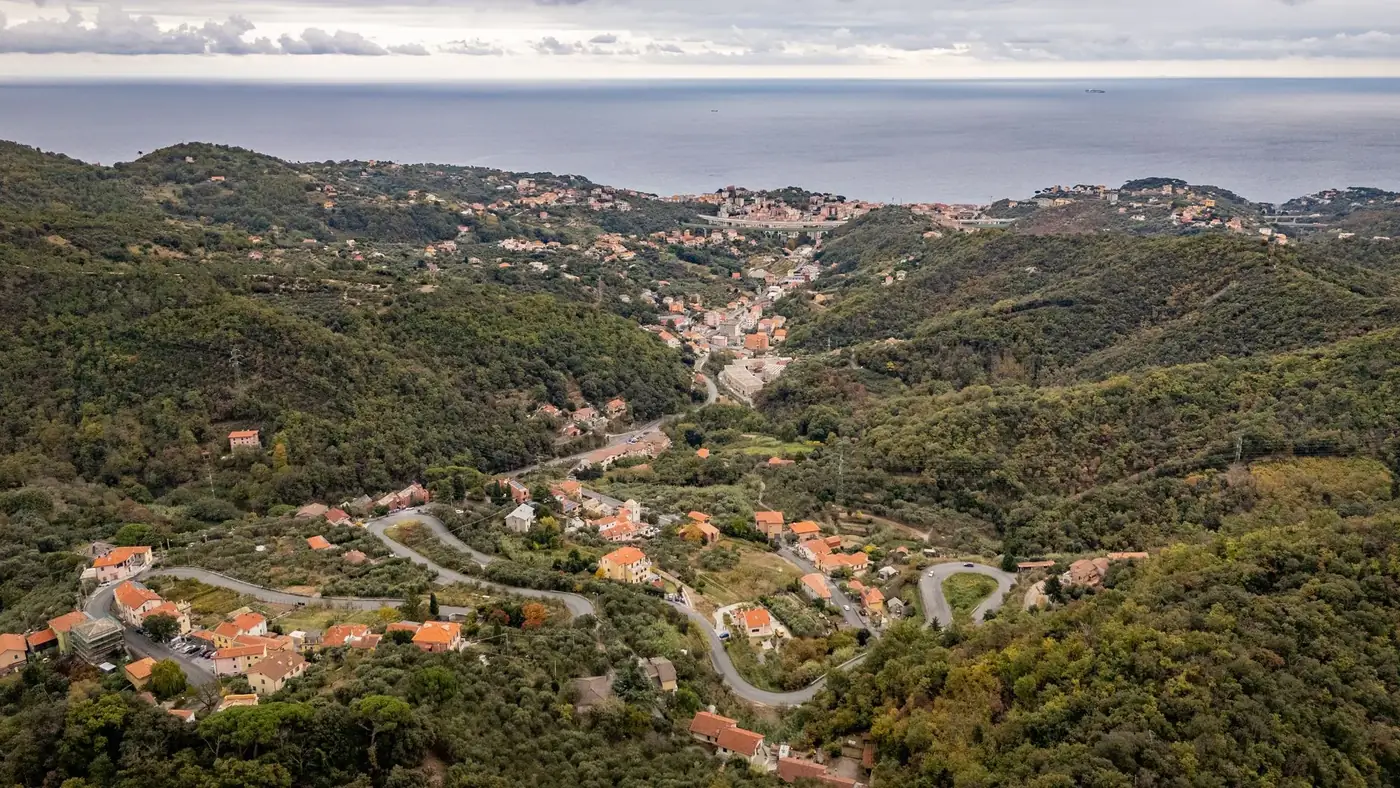 Scenic aerial view of Gameragna in Liguria, Italy showcasing winding roads and lush landscapes.