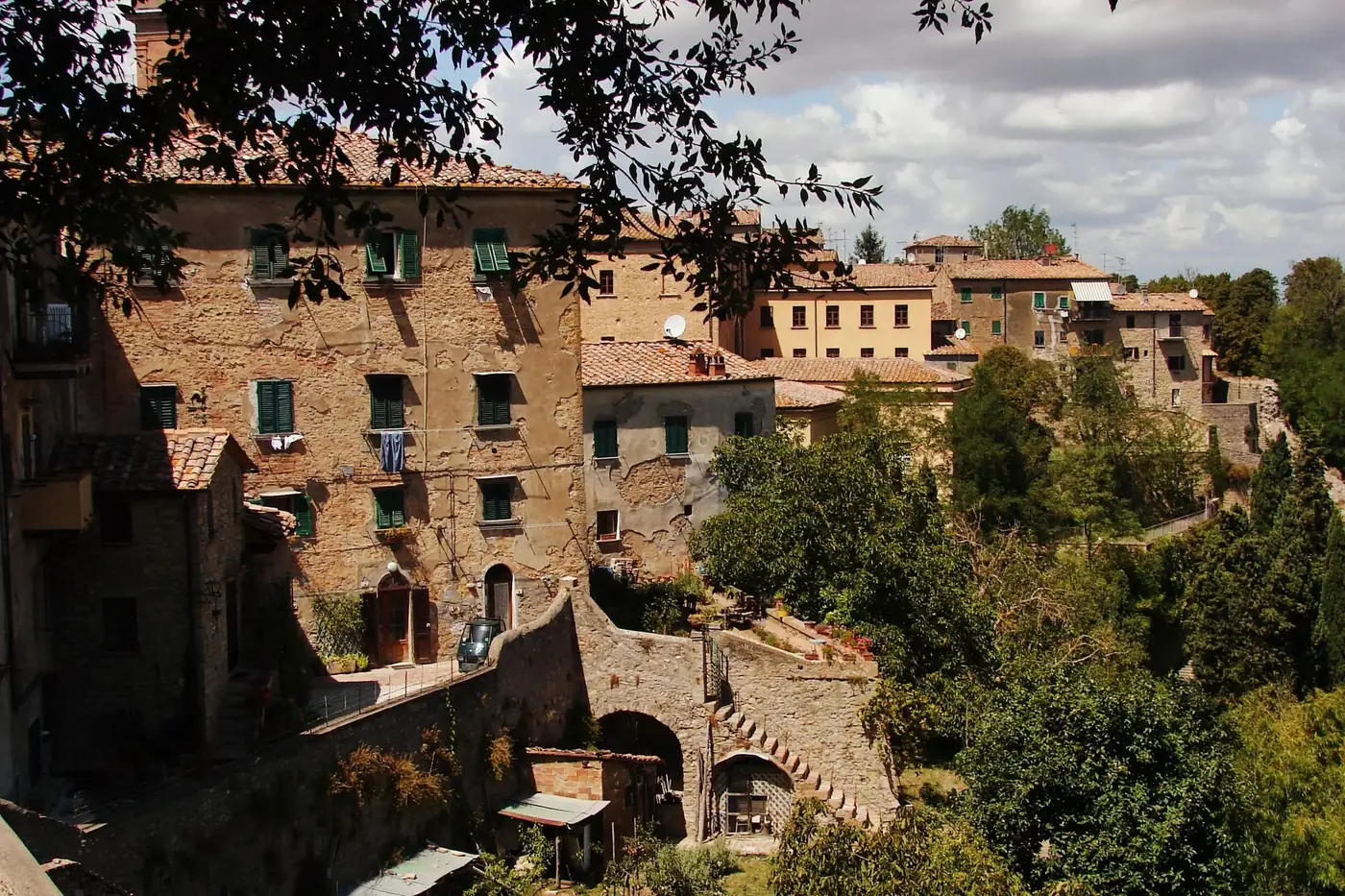 Discover the rustic charm of Volterra's ancient buildings nestled in Tuscany's landscape.