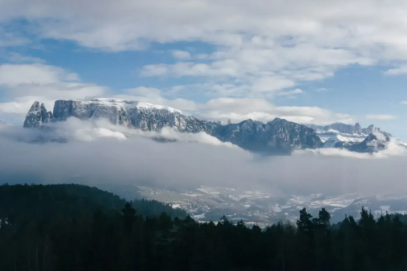 Panoramic view of the Dolomites shrouded in clouds in Trentino-Alto Adige, Italy.