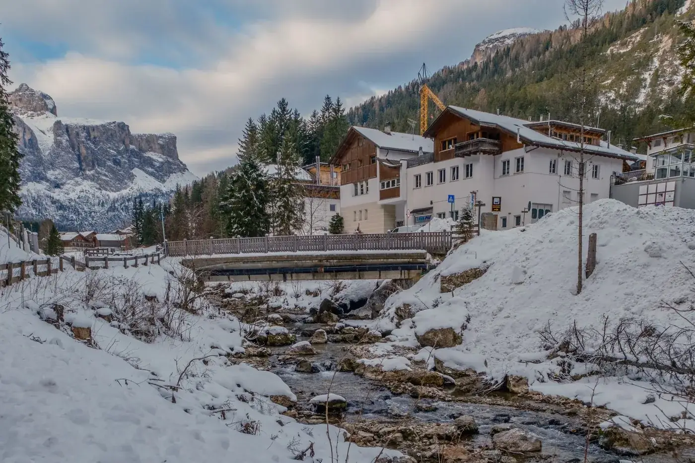 Picturesque snowy village in the Alps with mountain backdrop. Perfect winter destination.