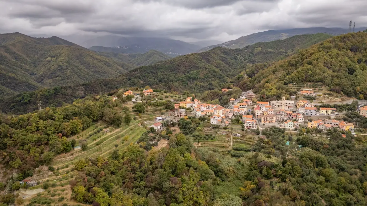 Scenic aerial view of Gameragna village surrounded by lush hills, Liguria, Italy.