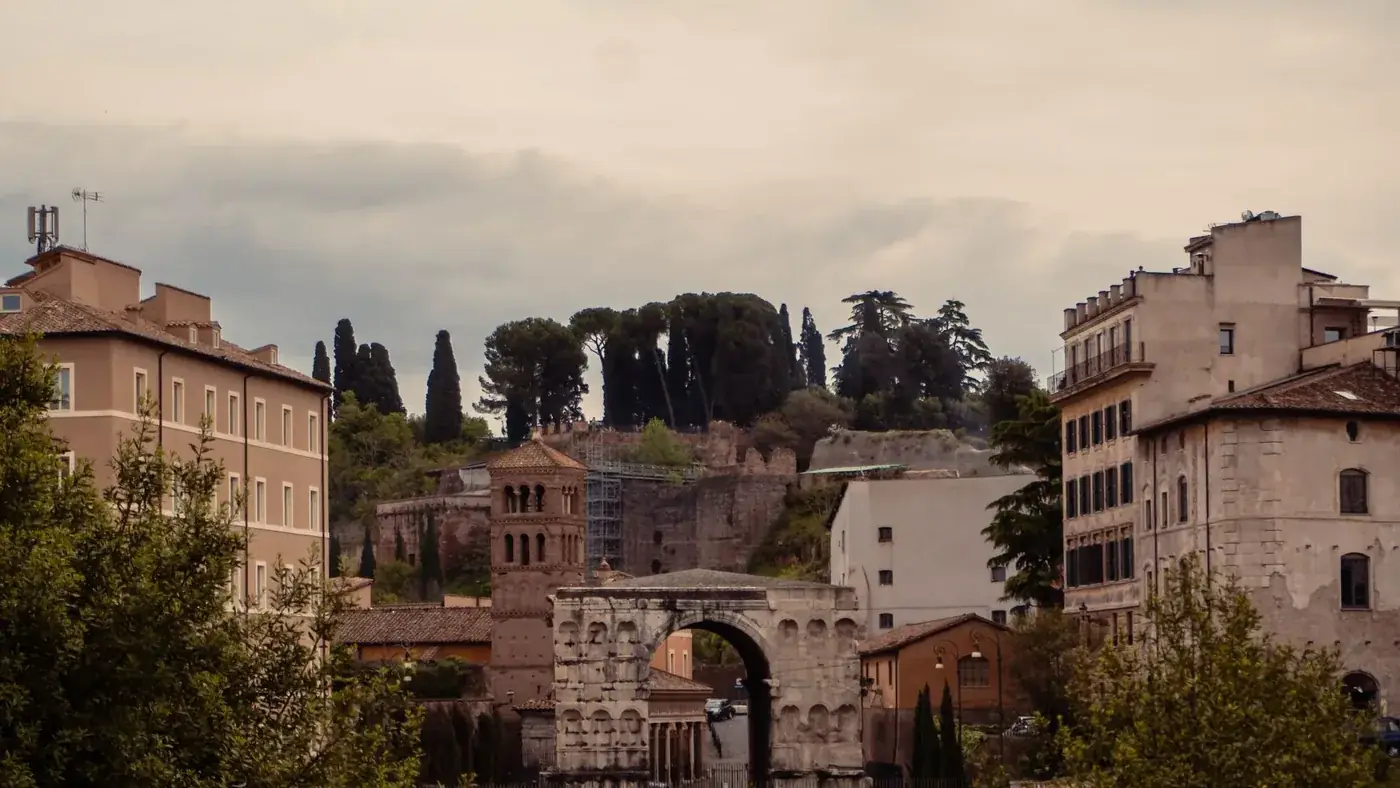 Capture of the ancient Arch of Janus amidst the charming architecture of Rome.