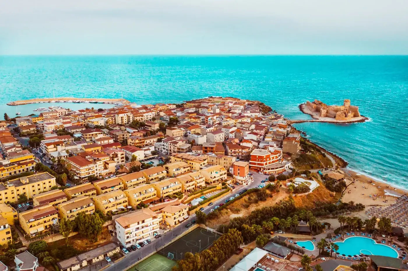 Explore the stunning coastal landscape of Capo Rizzuto in Calabria, Italy, featuring historic fortresses and vibrant towns.