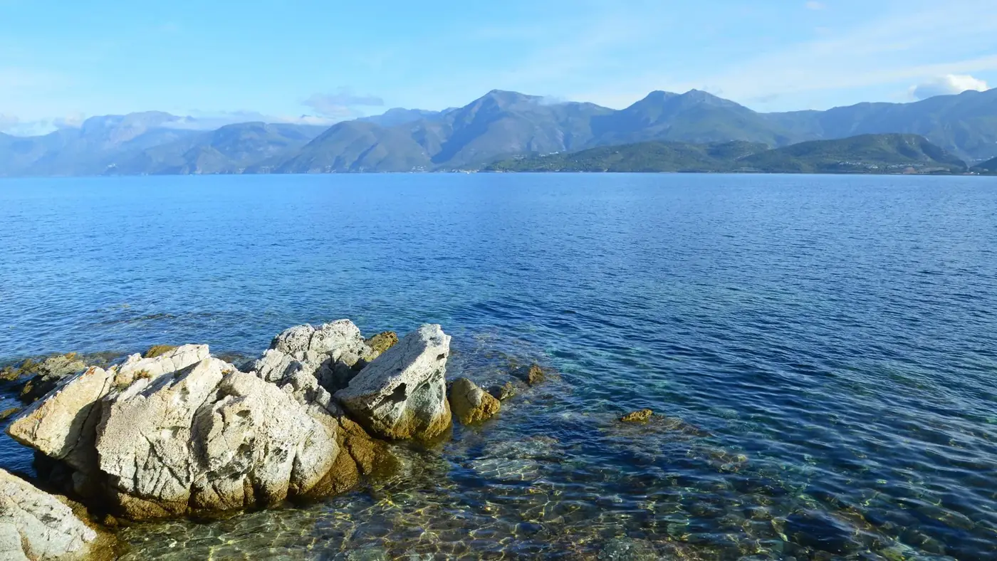 Breathtaking coastal view of Patrimonio, Corsica, featuring rocky shorelines and serene blue waters.