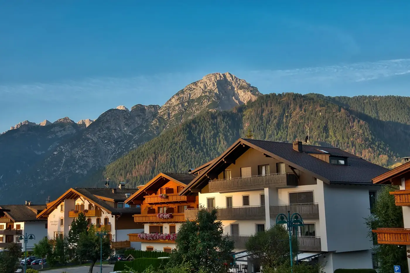 Idyllic village in Dobbiaco, Italy with stunning mountain views at sunrise.