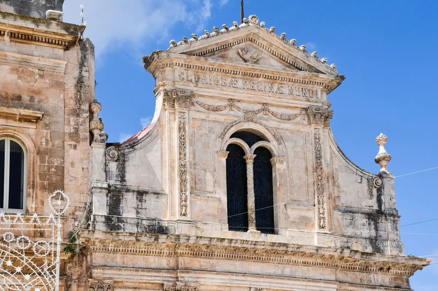 Close-up of ornate Baroque architecture in Apulia, Italy under clear blue sky