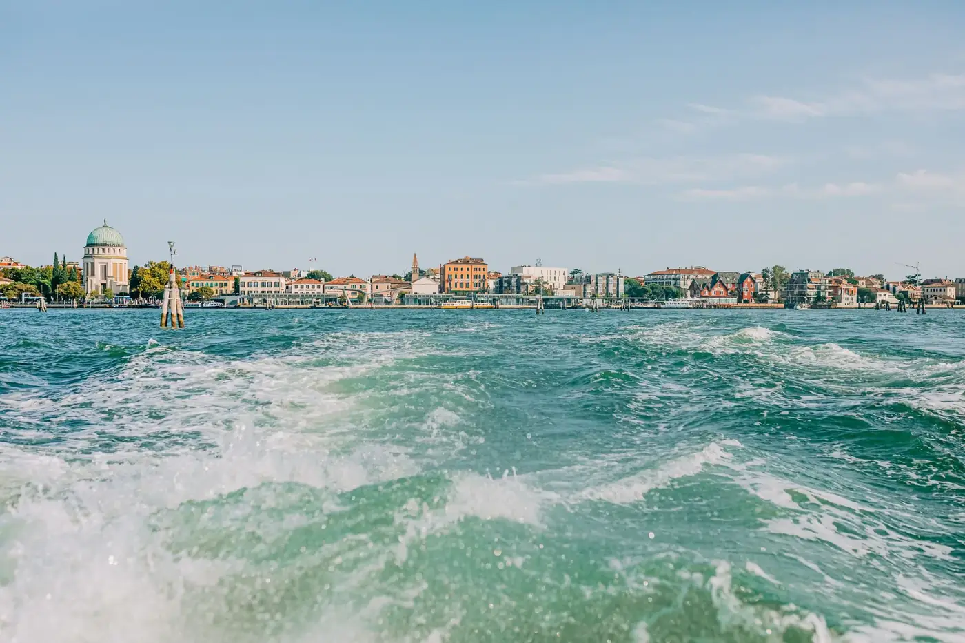 A vibrant view of Venice cityscape from the water, featuring historic architecture.