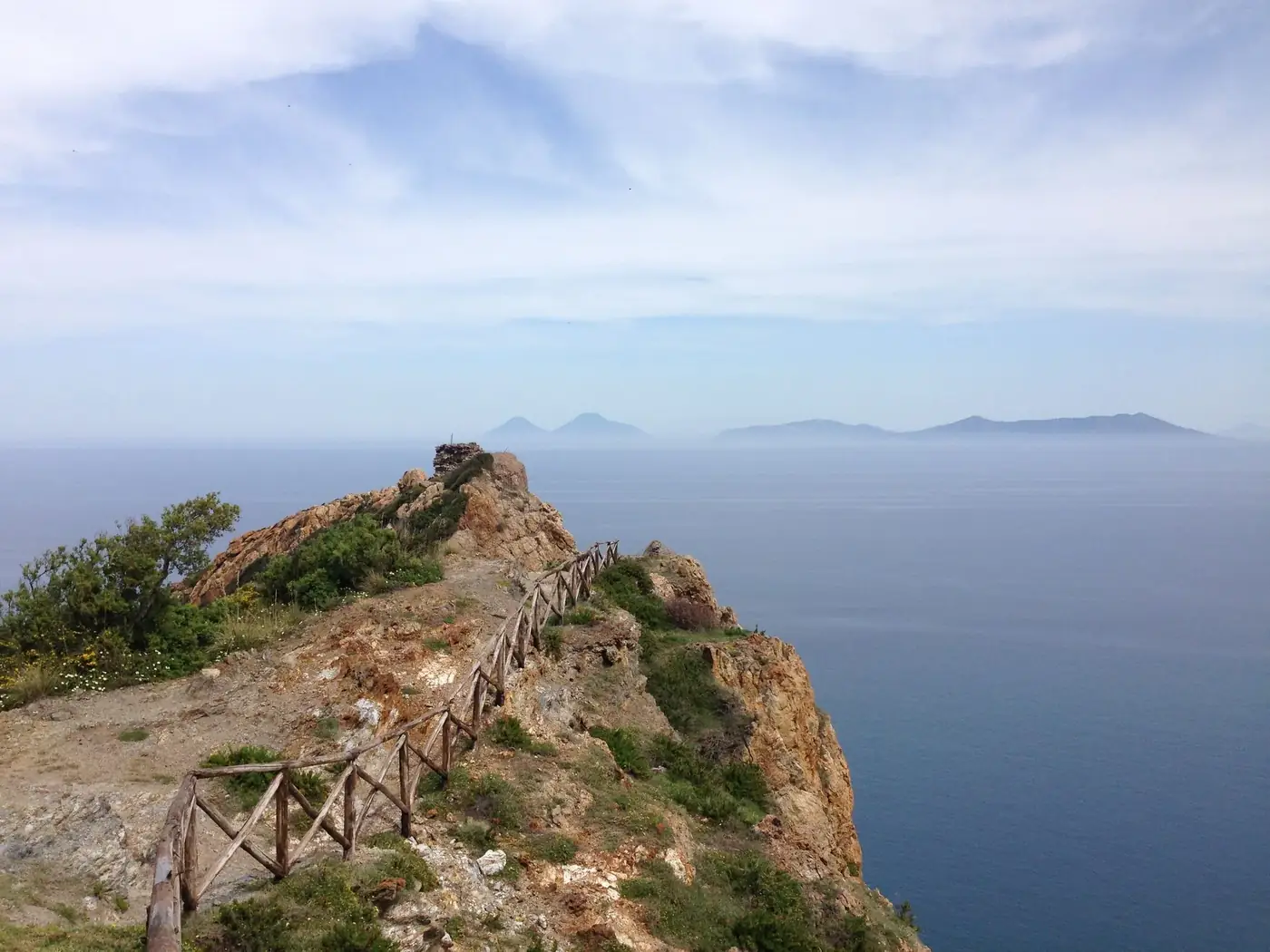 Breathtaking view of the Gioiosa Marea coastline in Sicily, featuring a rugged cliff and azure sea.