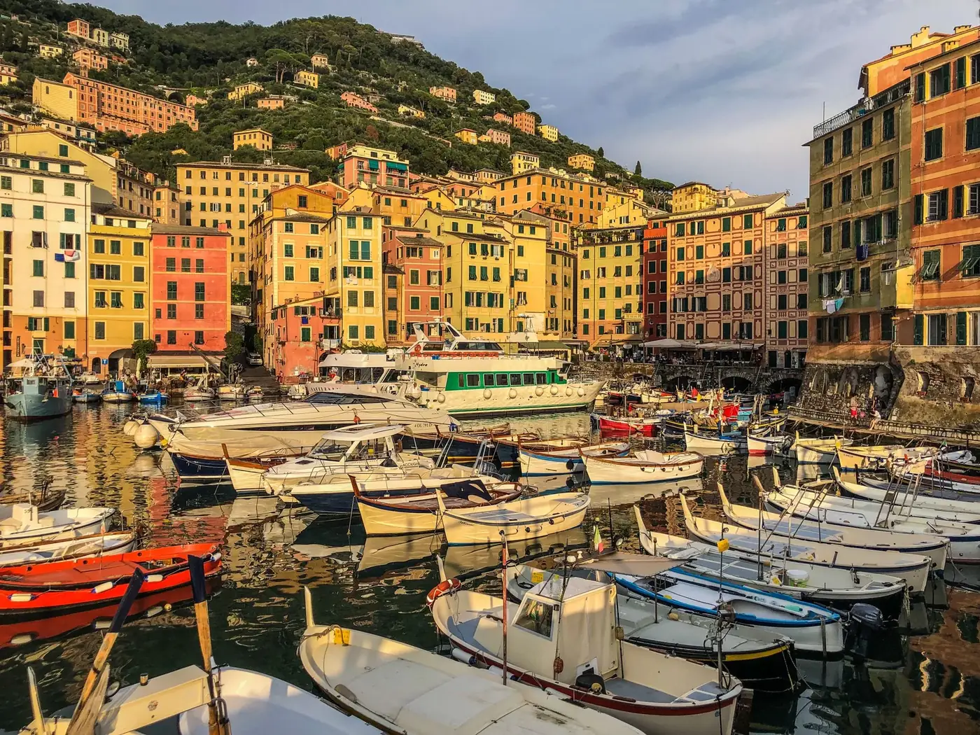 Vibrant boats docked at Camogli's colorful waterfront, Liguria, Italy.