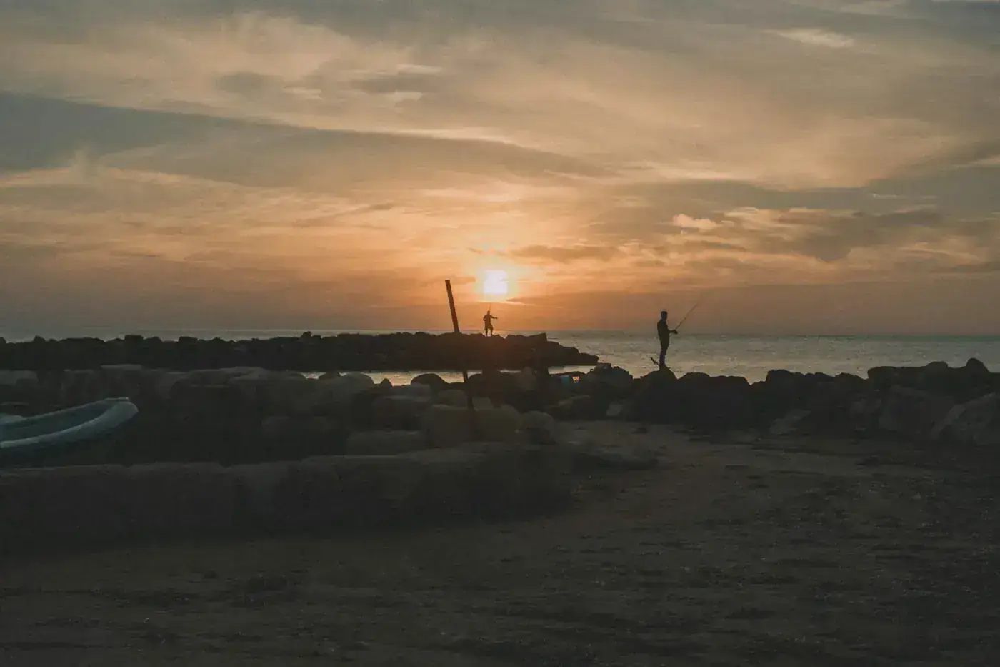 a sunset over a rocky beach