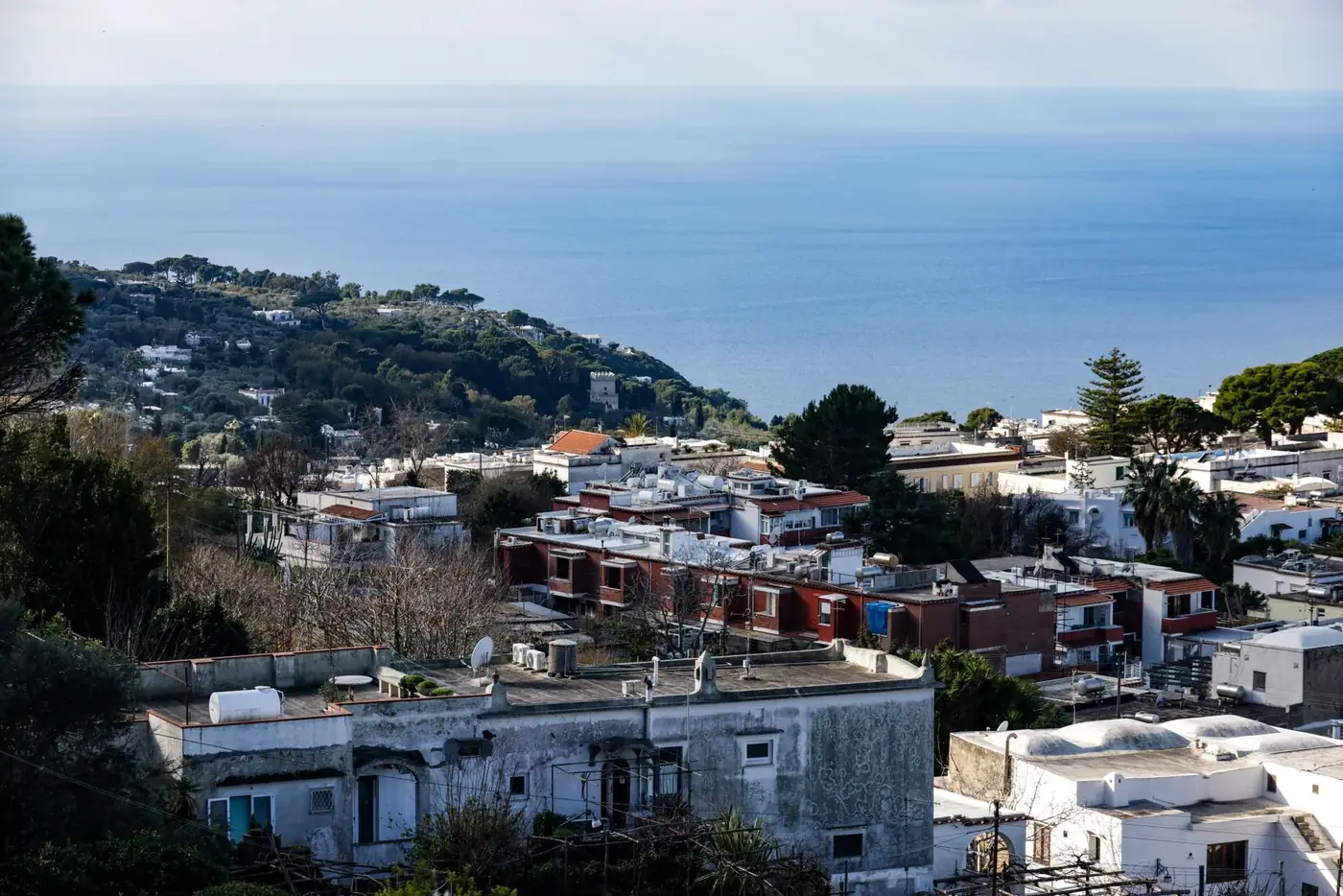 Aerial view of Capri's coastline with Mediterranean Sea backdrop and charming Italian architecture.