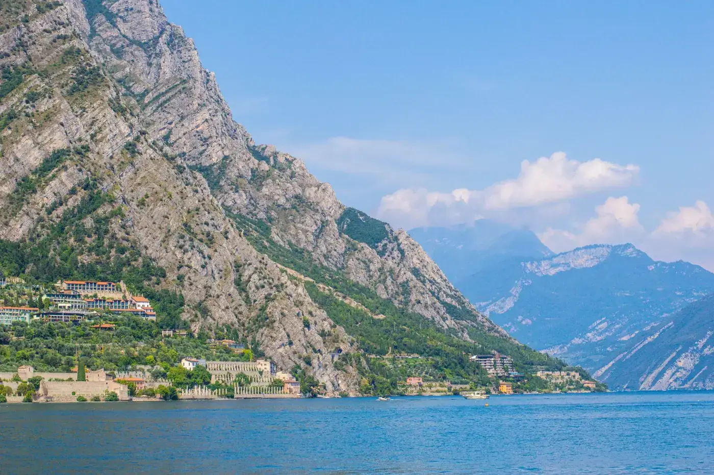 Breathtaking view of Lake Garda's mountains in Riva del Garda, Italy, under a clear blue sky.
