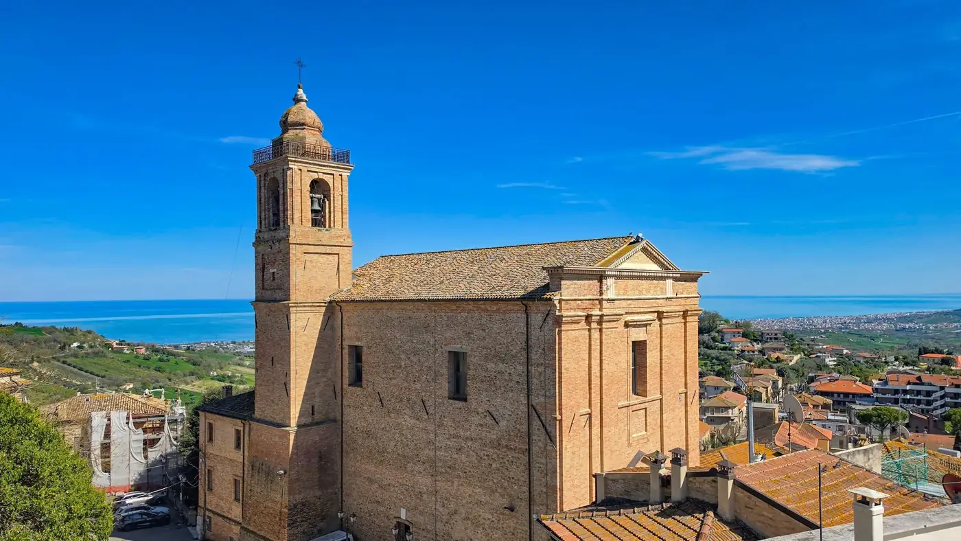 A picturesque view of a historic church near the Adriatic Sea, capturing architectural beauty and coastal landscape.