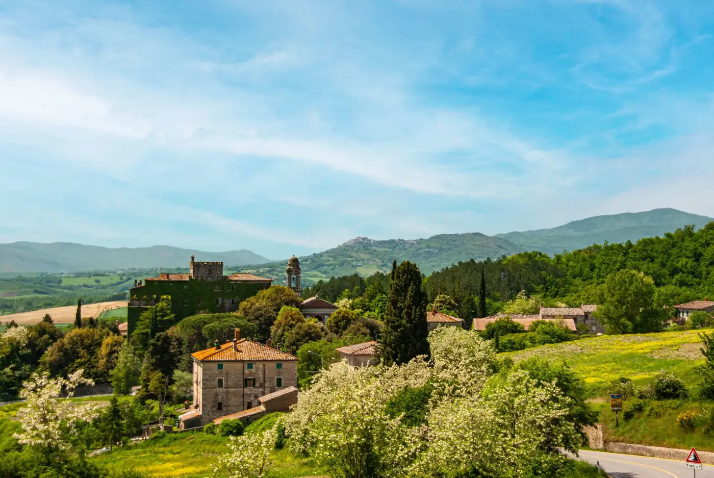 Breathtaking landscape of San Gimignano in Tuscany with rolling hills, medieval architecture, and vibrant greenery.
