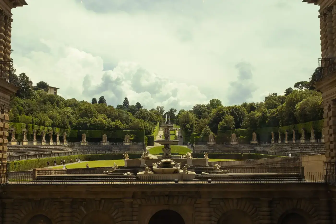 Panoramic view of Boboli Gardens from Pitti Palace in Florence, showcasing lush greenery and classic architecture.