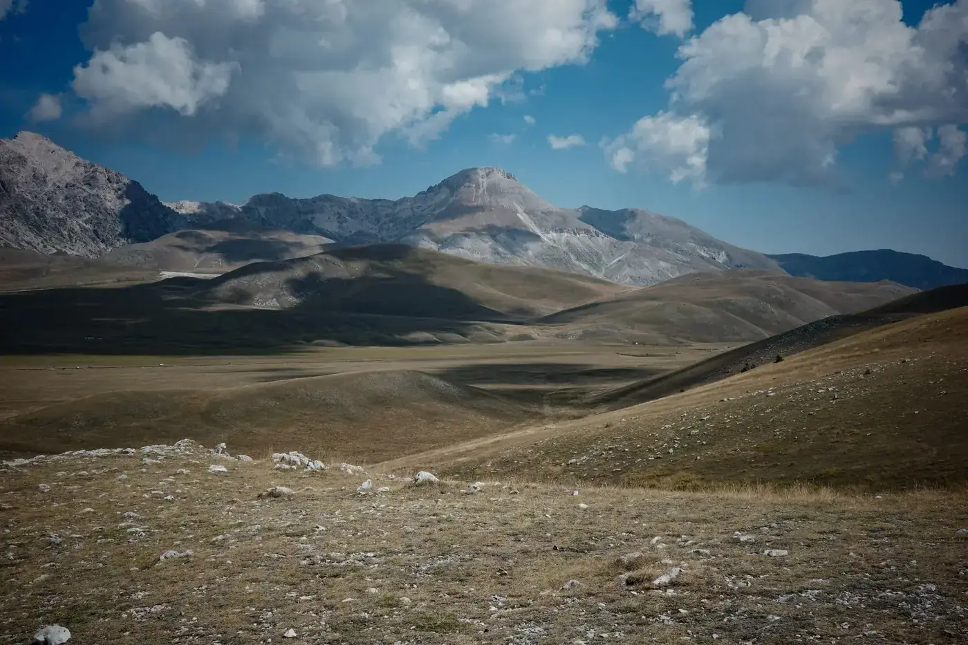 Scenic view of Gran Sasso mountains in Abruzzo, Italy with dramatic clouds.