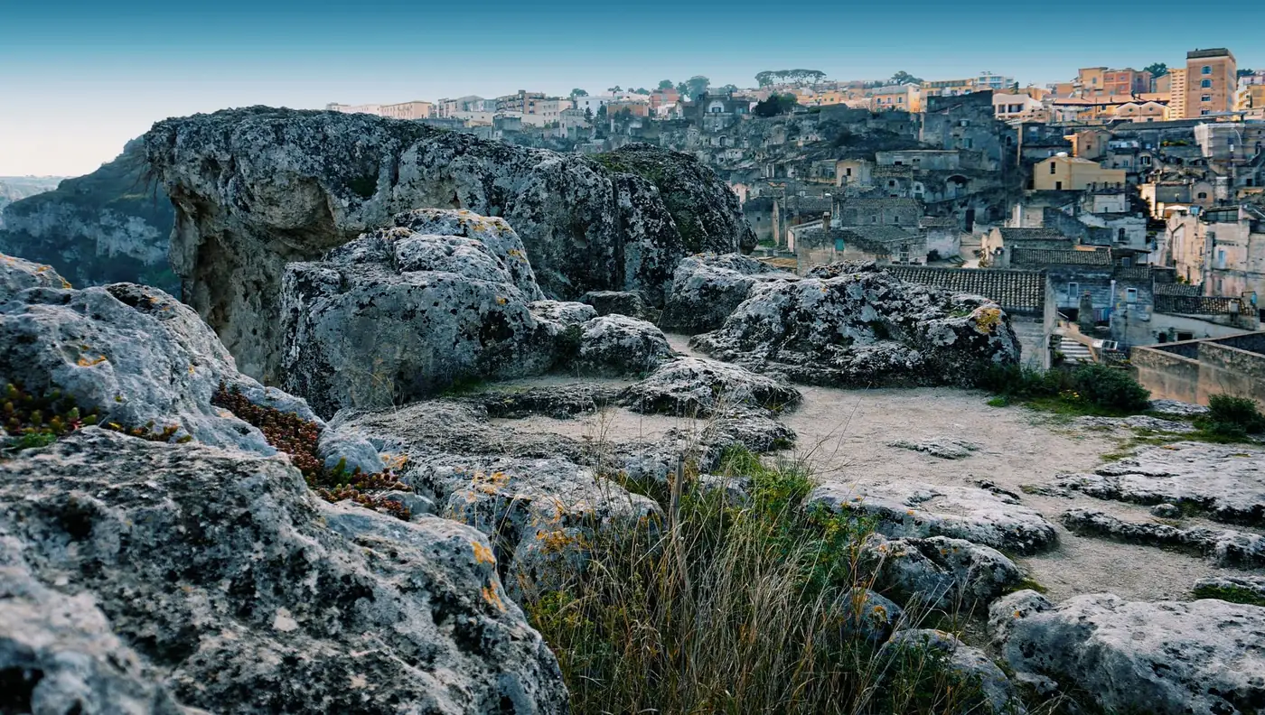 Beautiful landscape of rocky terrain overlooking the historic cityscape of Matera, Italy.