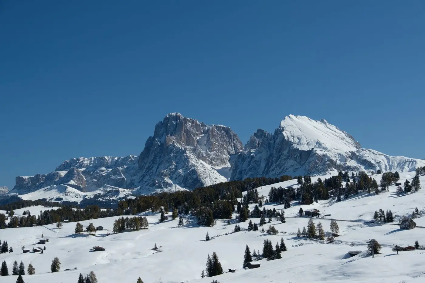 Beautiful snow-covered Dolomite mountains under clear blue skies in Trentino-South Tyrol.