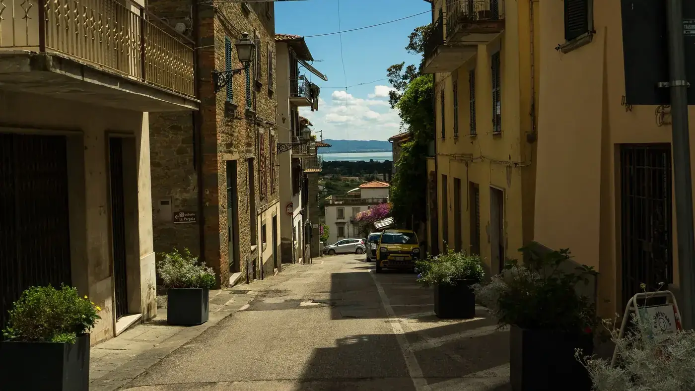 Picturesque street with view of Lake Trasimeno in Tuoro sul Trasimeno, Italy.