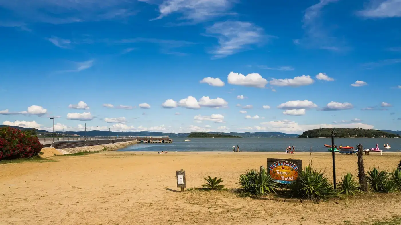 A serene summer day at a sandy beach on Lake Trasimeno, Umbria, Italy.