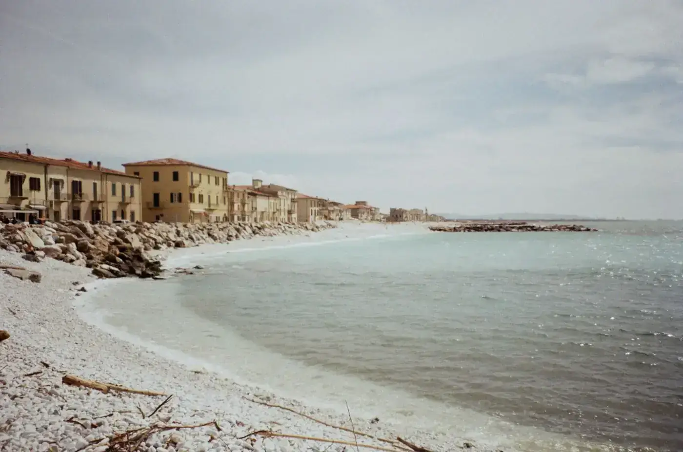 Tranquil beachfront in Piza, Tuscany captured on a serene day with clear skies.