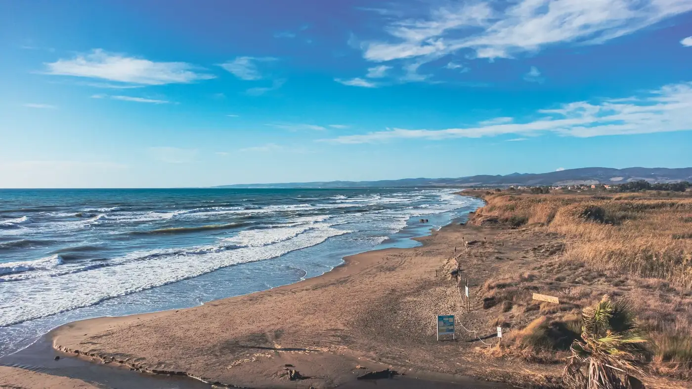 Explore the stunning coastline of Ladispoli, Italy, featuring sandy beaches, ocean waves, and clear blue skies.