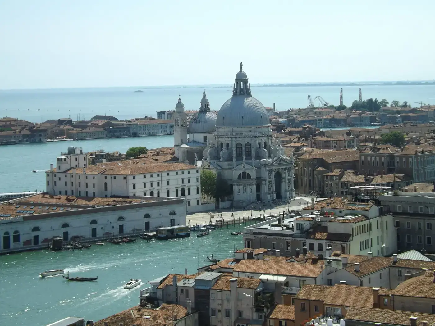 Stunning aerial view of Basilica di Santa Maria della Salute in Venice with surrounding canals and architecture.