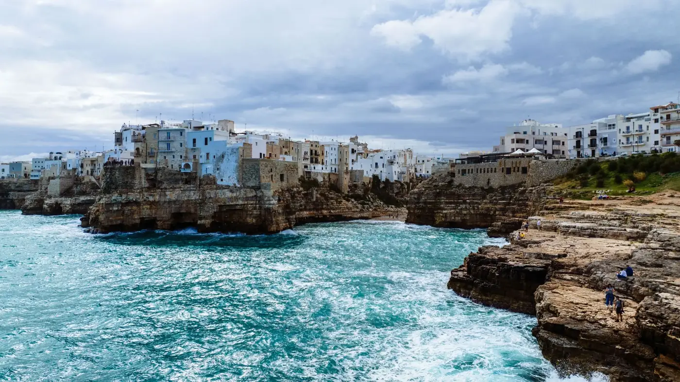 Stunning seascape of Polignano a Mare, Italy showcasing rocky cliffs and historic buildings.