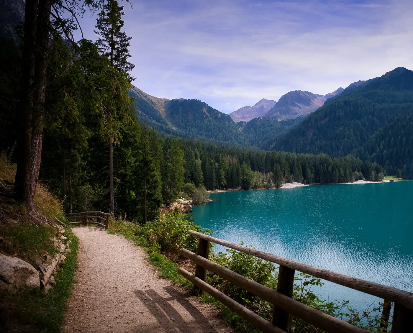 Explore the serene lake and mountain landscape in Rasen-Antholz, Trentino-Südtirol, Italy. Ideal for travel enthusiasts.