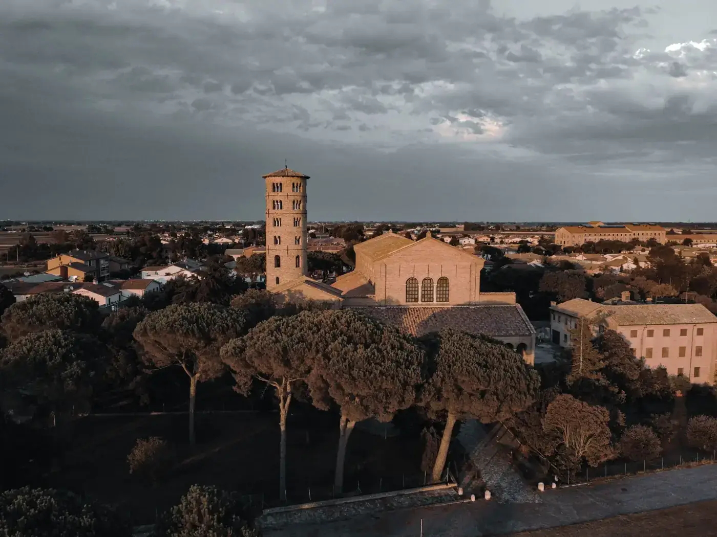 Aerial view of the historic Basilica of Sant'Apollinare in Classe with an overcast sky.