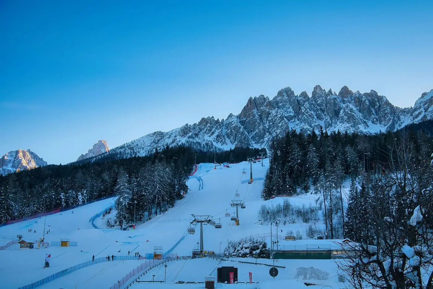 Capture the stunning winter landscape and ski lift at Innichen, Italy's Dolomites, perfect for winter sports enthusiasts