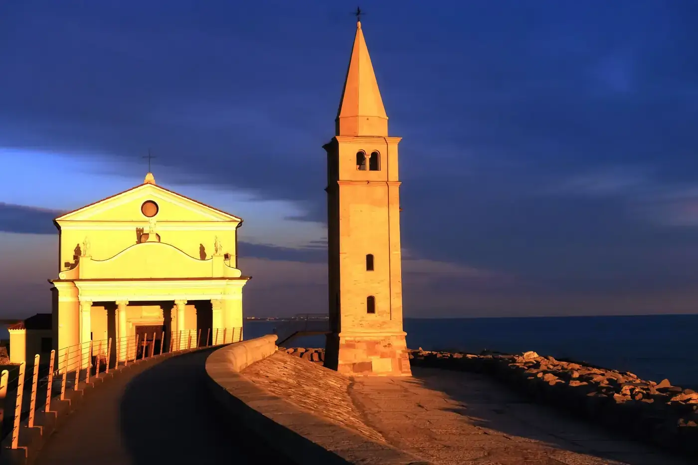 Dramatic sunset at the Church of the Blessed Virgin of the Angel in Caorle, Italy.