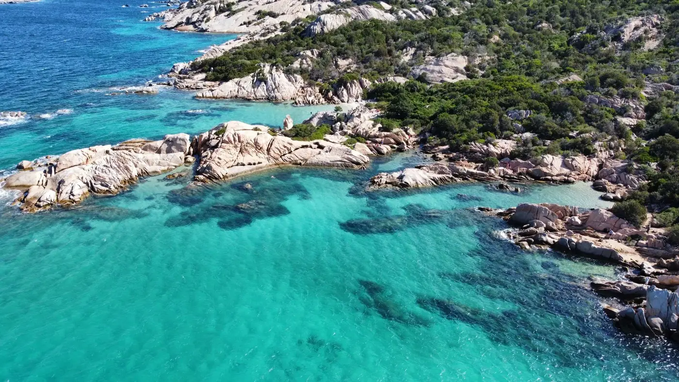 A stunning aerial view of San Teodoro, Sardinia showcasing rocky shores and vibrant turquoise waters.