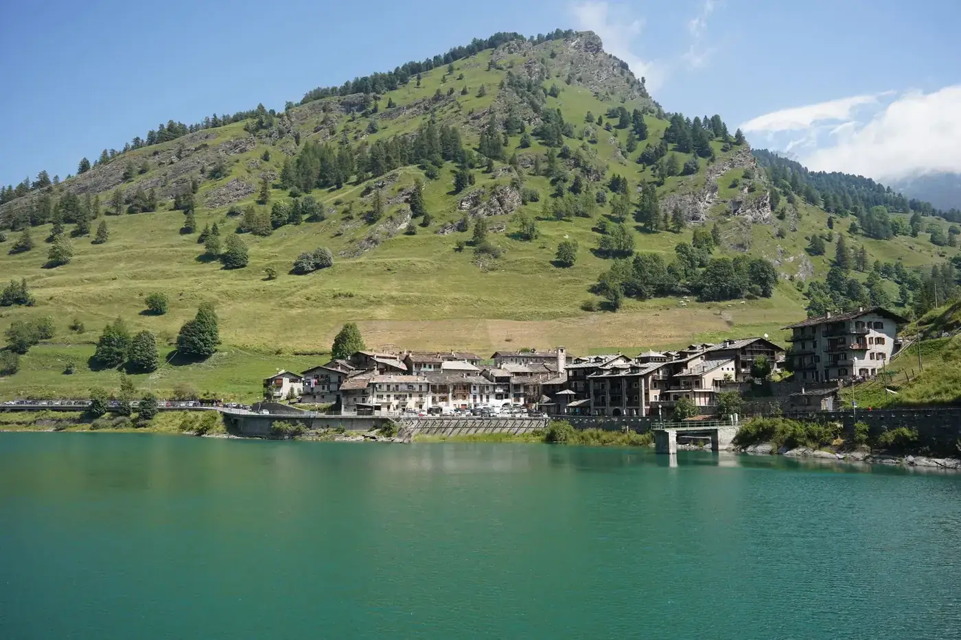 Picturesque mountain village by a tranquil lake in Castello, Piemonte, Italy.