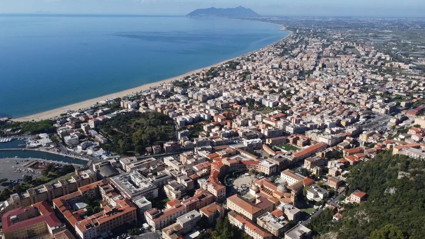 Stunning aerial view of Terracina, Italy, showcasing its coastline, cityscape, and Mediterranean Sea.