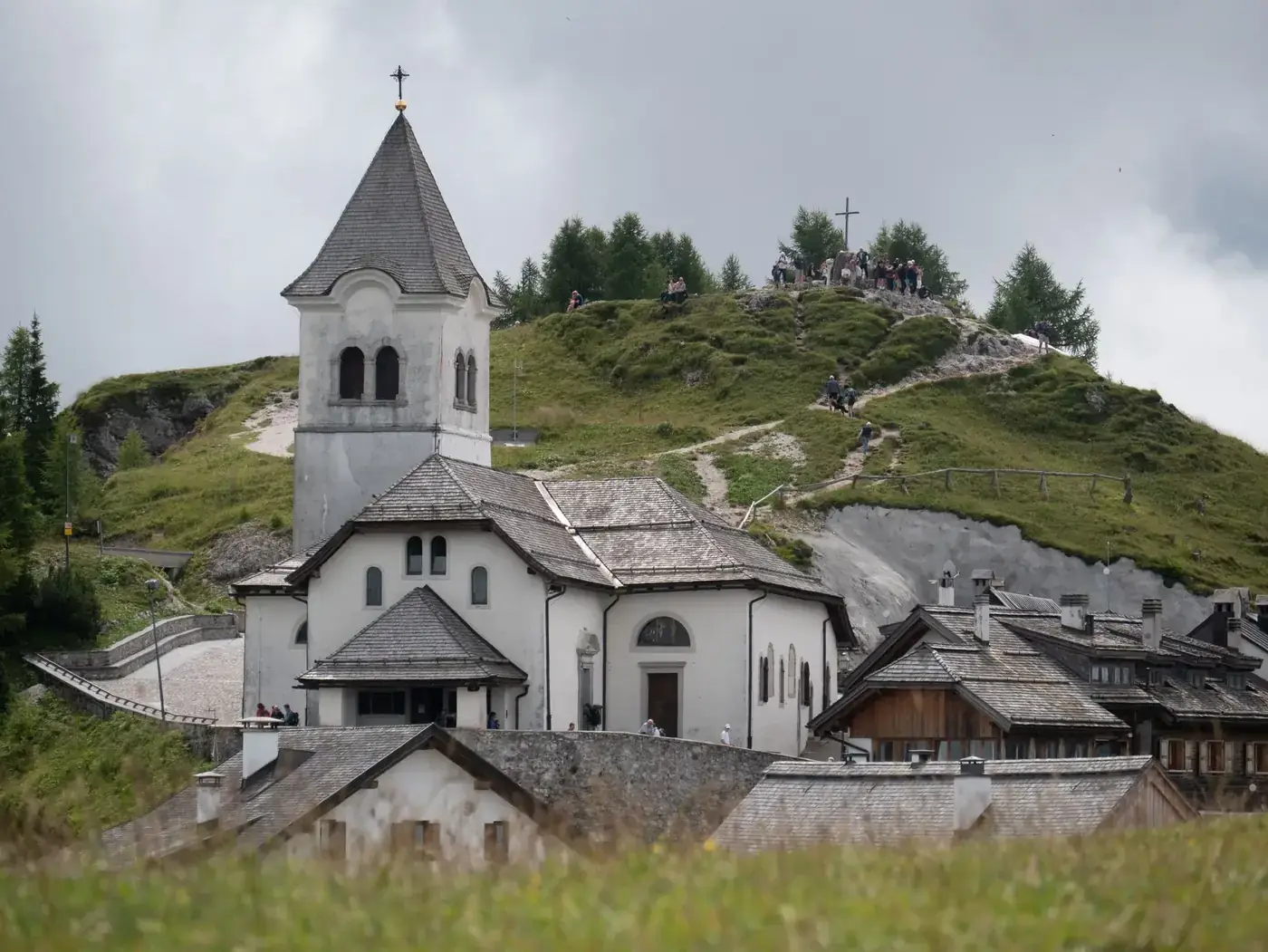 A picturesque view of Monte Lussari Sanctuary in Valbruna, Italy on a serene day.