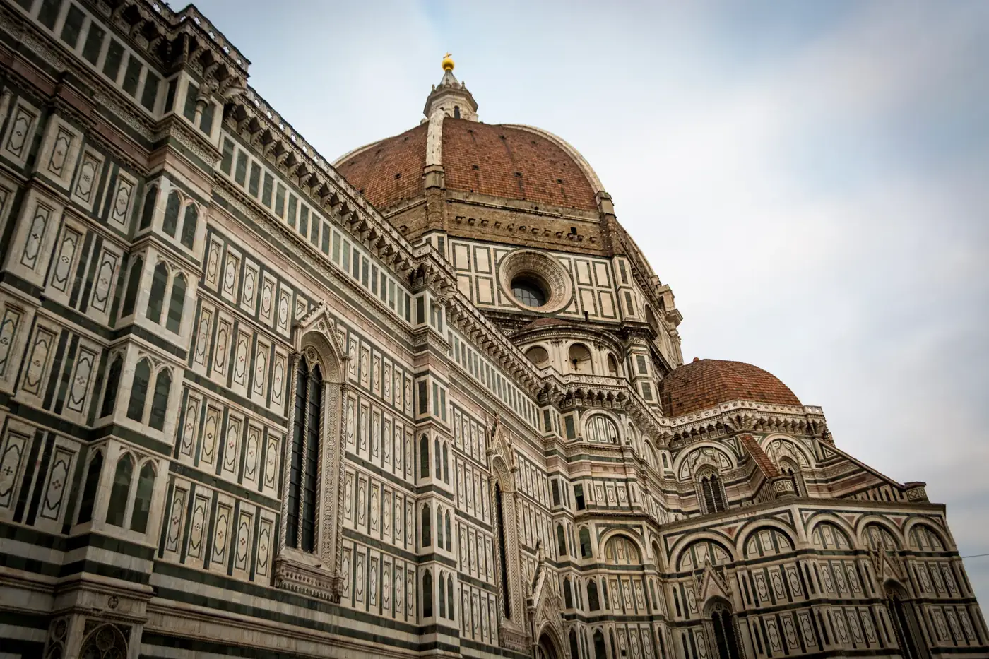 Close-up of Brunelleschi's Dome at Florence Cathedral, showcasing intricate architectural details.