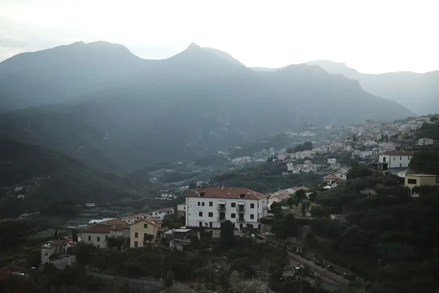 Scenic view of a mountain village in Italy during daytime, capturing the serene landscape.