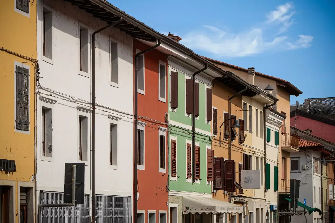 Vibrant facades of traditional Italian buildings in Palmanova, showcasing colorful architecture.