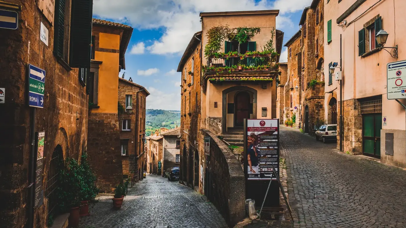 Explore the cobblestone streets and historic architecture of Orvieto, Italy, a picturesque travel destination.